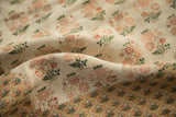 Delicate pink, green, red floral on ivory Persian brocade textile with finely patterned border.