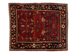 Antique Farahan Sarouk rug with a tree of life motif, abrashed red field, and dark navy floral border.