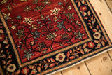 Collector Farahan Sarouk rug corner showing the serpent border and intact side cord selvage.