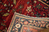 The secured end and short pile of an antique Farahan Sarouk rug with a detailed serpent border.