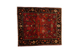 Antique Farahan Sarouk square rug with a sprawling tree of life design on an abrashed brick red field.