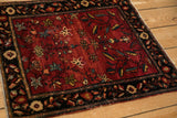 Heavily abrashed red ground with a tree of life design on an antique Farahan Sarouk square rug.