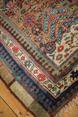 Reciprocating pawn design motif in the gem-toned borders of an antique Serab collector carpet.