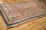 Angled perspective of a collector's antique Serab carpet with gem-toned geometric medallions.