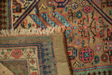 A folded corner of an antique Serab rug reveals its hand-knotted pile and woven foundation.