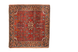 Vintage Farahan Sarouk square rug with a central floral medallion on a brick red, densely vined field.