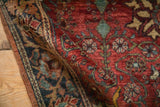 The dense, hand-knotted wool pile of a vintage Farahan Sarouk, showing detailed floral work and patina.