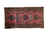 Vintage Persian Mehriban rug with blue floral medallions and palmettes on a pale magenta field.