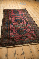 High-angle view of a vintage Persian Mehriban rug's linear pattern with sapphire blue palmettes.