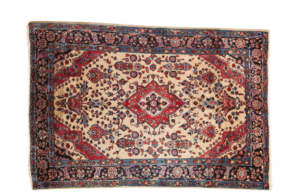 Antique Mohajeran Sarouk rug with a red center medallion and sprawling florals on a rare ivory ground.