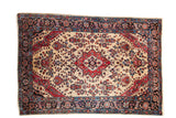 Antique Mohajeran Sarouk rug with a red center medallion and sprawling florals on a rare ivory ground.