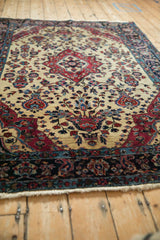 A low angle view highlighting the textured pile and traditional floral design of the antique Mohajeran Sarouk.