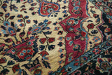 Hand-knotted texture showing raspberry red boteh and floral motifs on an antique Sarouk rug.