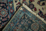 Hand-knotted foundation and fringe detail of an antique Mohajeran Sarouk rug corner.
