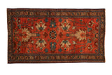 Antique Mehreban rug with large geometric palmettes in sky blue and ivory over a raspberry red field.