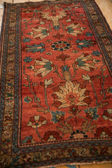 Angled view of the geometric floral delineation and low pile texture of an antique Mehreban rug.