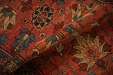 A fold reveals the supple texture and geometric floral palmettes of an antique Mehreban rug.