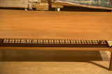 Close-up showing the vintage patina and light scuffs on the teak coffee table surface.