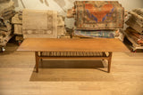 Vintage Danish modern coffee table with a long teak top and distinctive sled legs.