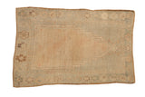 Vintage distressed Oushak rug with a stepped prayer design in soft seafoam green, beige, and mauve.