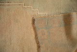 Hand-knotted foundation and reverse weave of a distressed vintage Turkish Oushak rug.