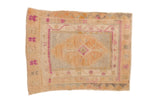 Distressed vintage Oushak rug with a central diamond medallion in dusty gold, oxidized silver, and magenta.