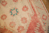 Detail of the distressed Oushak runner's mostly even wear and pale floral motifs.