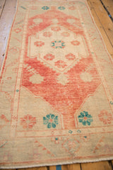 Angled view of the distressed Oushak runner showing its worn texture and medallion.