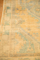 Close-up of the distressed Oushak's texture, with the foundation weave visible through the low pile.