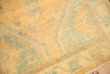 Mostly even wear showing the saffron and turquoise knot heads and ribbed foundation of the distressed Oushak rug.
