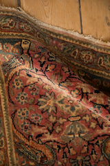 Angled view showing the soft pile and time-worn edge of the vintage Persian rug.