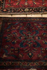 Lustrous wool and fine weave of an antique Persian Lilihan rug shown at a low angle.