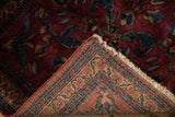 A folded corner on an antique Lilihan rug reveals the fine hand-knotted weave and back foundation.