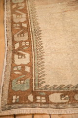 Worn geometric border and intact side cord selvage of a vintage distressed Oushak rug.