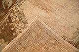 A vintage Turkish Oushak rug corner flipped to reveal the hand-knotted foundation.