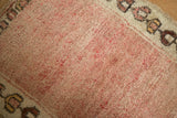 Close-up of the short pile showing rose color variations and a geometric border.