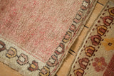 Textured short pile and floral geometric border on a distressed vintage Anatolian rug.