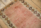 Distressed wool pile and geometric floral border on the corner of a vintage Anatolian mat.