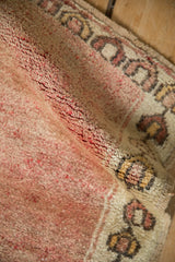 Time-softened patina and short pile texture on a distressed vintage Anatolian mat.