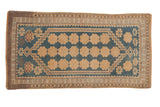 Vintage distressed Oushak rug with ivory floral blossoms in columns on a stepped sky blue field.