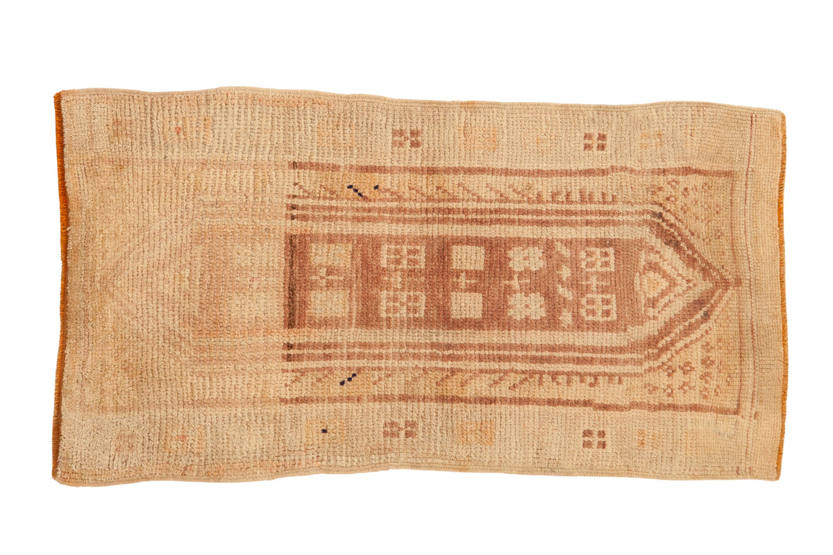 Vintage distressed Anatolian rug with a central geometric cartouche in faded coffee brown and antique ivory.