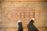 A distressed vintage Anatolian rug runner shown on the floor for a sense of scale and texture.