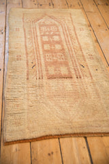 Angled view of a vintage Anatolian rug showcasing its evenly worn pile and soft, dusty colors.