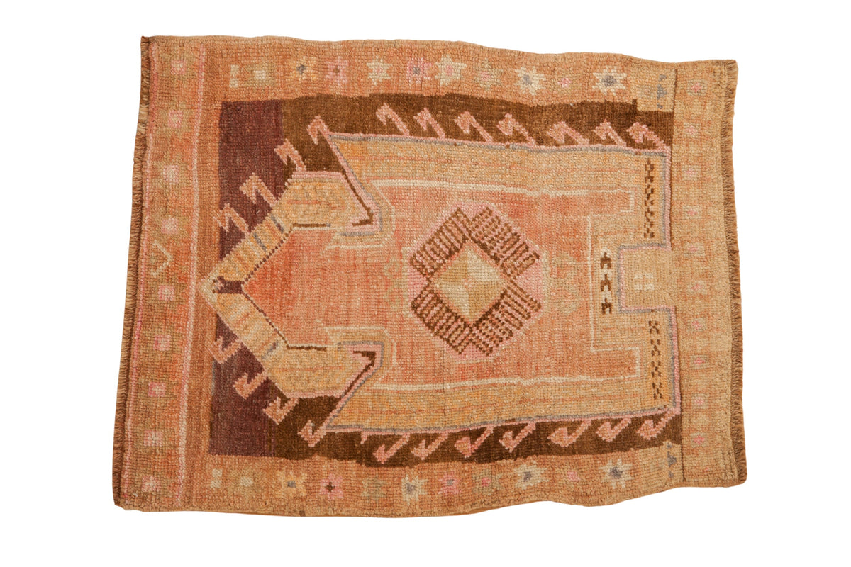 Vintage distressed Kars rug with a geometric arrowed prayer design in pink, grapefruit, and coffee brown tones.