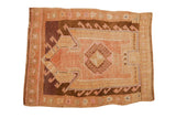 Vintage distressed Kars rug with a geometric arrowed prayer design in pink, grapefruit, and coffee brown tones.