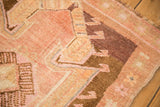 Even wear across the distressed hand-knotted pile of the vintage Turkish Kars rug.