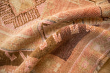 A gentle fold highlights the distressed, even wear and hand-knotted texture of a vintage Kars rug.