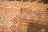 Folded corner of the distressed Kars rug showing the hand-knotted back and low pile texture.