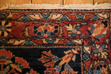 Intact side cord selvage and floral pinwheel border on an antique Persian Lilihan rug.