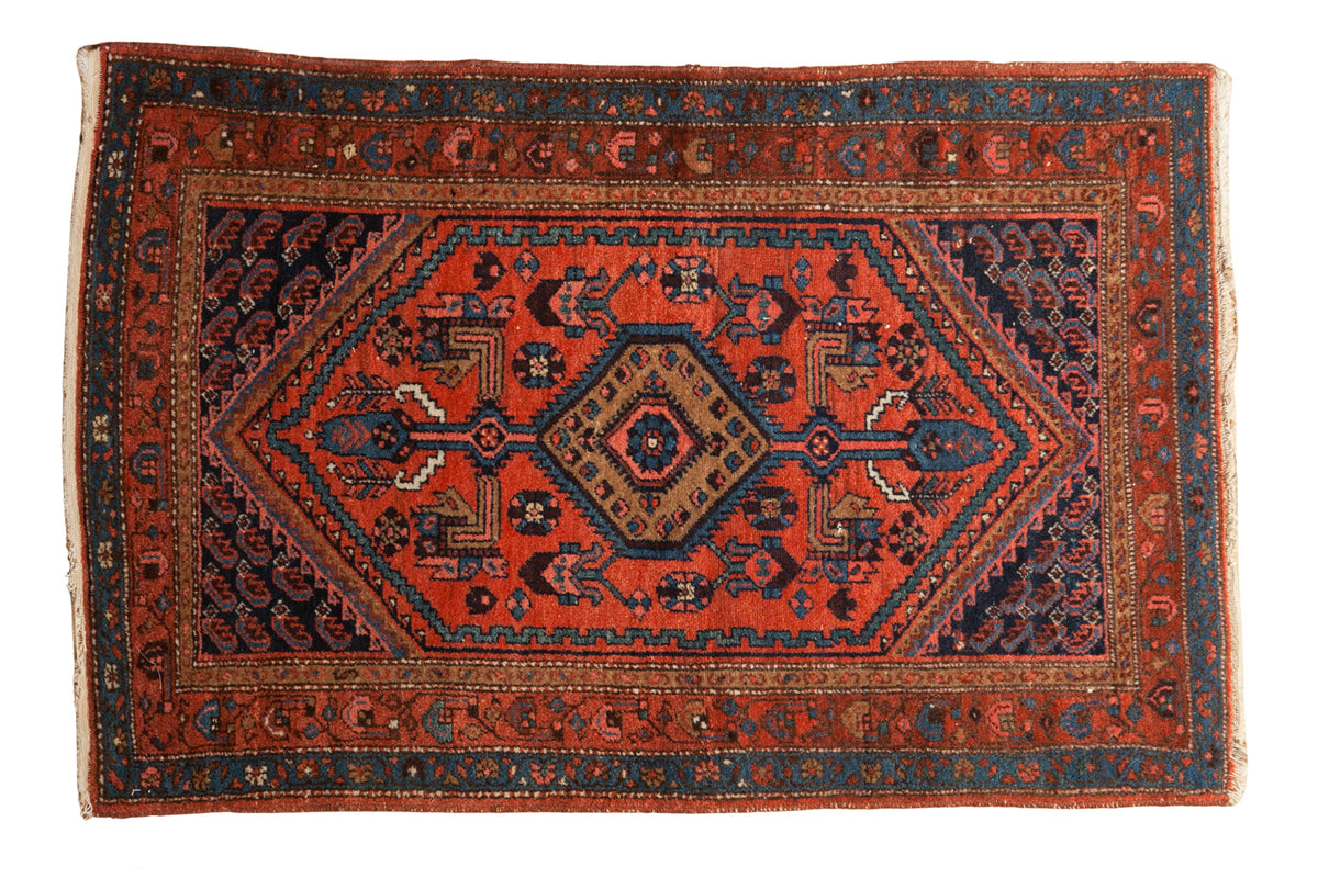 Vintage Kurdish Hamadan rug with a sharp serrated hexagonal medallion in red, navy blue, and brown tones.